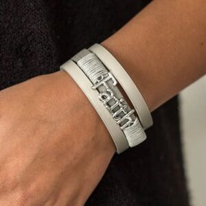 Gray leather bands layer Gray cording wraps around the center silver charm Faith